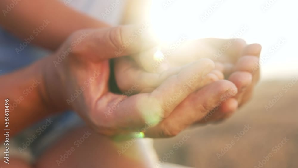 Family teamwork. Hands of child in hands of the parent. Safety and security in family. People's hands in the rays of sun at sunset. Community support. Mother love. Father day in the park at sunset. Family teamwork. Hands of child in hands of the parent. Safety and security in family. People's hands in the rays of sun at sunset. Community support. Mother love. Father day in the park at sunset.