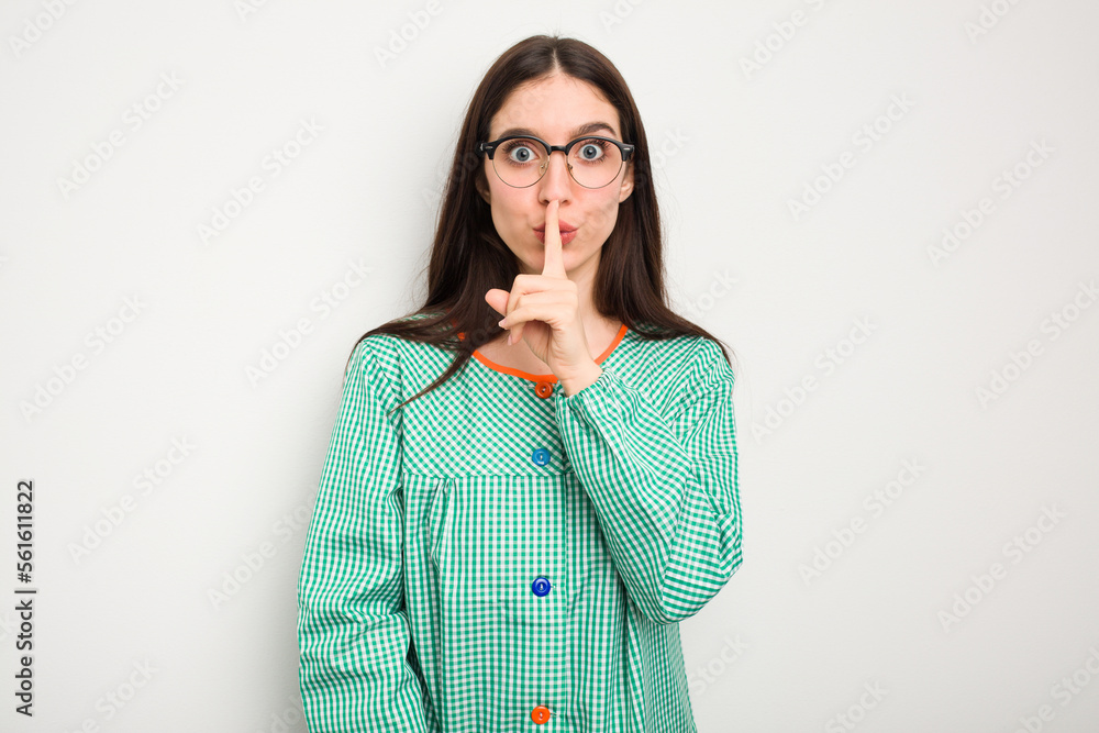 Young caucasian child education teacher isolated on white background keeping a secret or asking for silence. Young caucasian child education teacher isolated on white background keeping a secret or asking for silence.