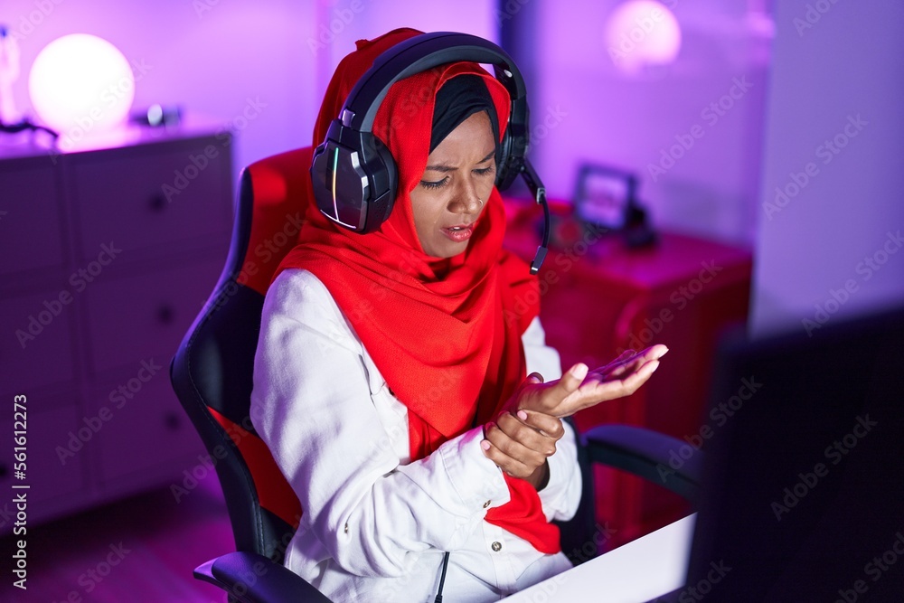 Young beautiful woman streamer stressed using computer at gaming room