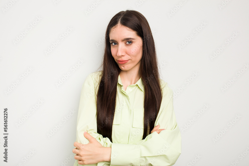 Young caucasian woman isolated on white background suspicious, uncertain, examining you. Young caucasian woman isolated on white background suspicious, uncertain, examining you.