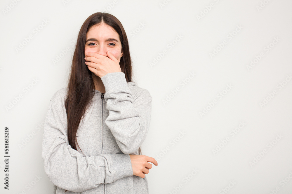 Young caucasian woman isolated on white background laughing happy, carefree, natural emotion. Young caucasian woman isolated on white background laughing happy, carefree, natural emotion.