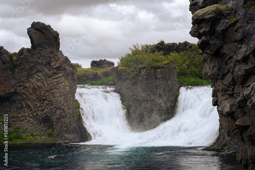 Scenic view of Hjalparfoss waterfall surrounded by basalt rocks, south of Iceland