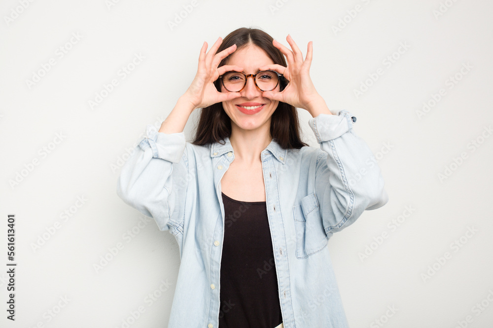 Young caucasian woman isolated on white background excited keeping ok gesture on eye. Young caucasian woman isolated on white background excited keeping ok gesture on eye.