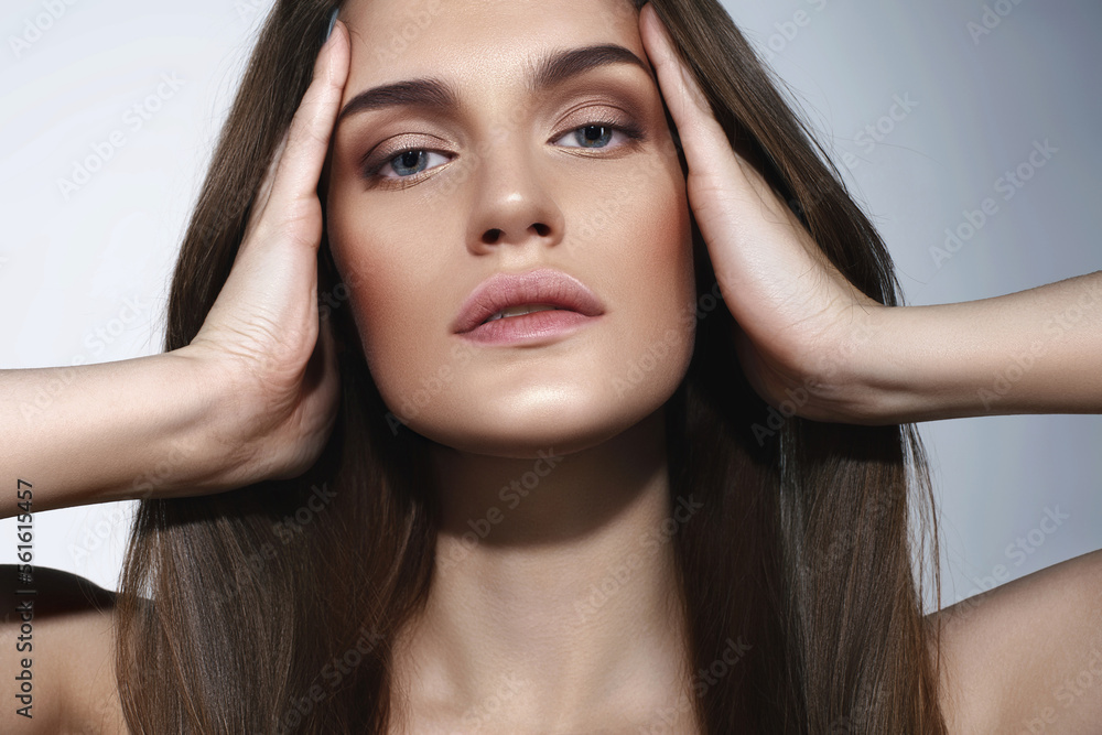 Beautiful caucasian girl with perfect skin and natural makeup on gray background Beautiful caucasian girl with perfect skin and natural makeup on gray background