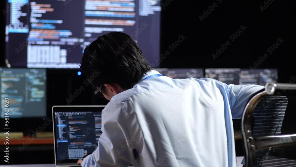 Close Up Back View Of Asian Male Programmer Having A Backache While Writing Code By A Laptop Using Multiple Monitors Showing Database On Terminal Window Desktops In The Office
Close Up Back View Of Asian Male Programmer Having A Backache While Writing Code By A Laptop Using Multiple Monitors Showing Database On Terminal Window Desktops In The Office