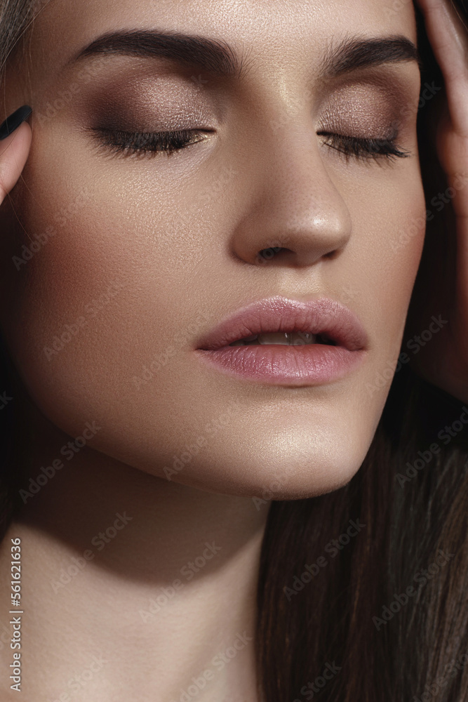 Young Caucasian girl with perfect glowing skin and natural makeup in close-up Young Caucasian girl with perfect glowing skin and natural makeup in close-up