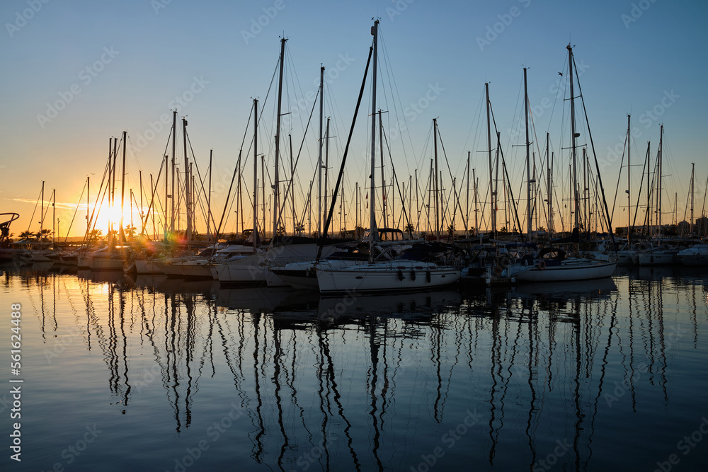 Yacht parking in the marina at sunset.
Sea bay with yachts at sunset.
Moored yachts. Marina, port. reflection of boat masts in sea water at sunset. Torrevieja, Alicante, Spain