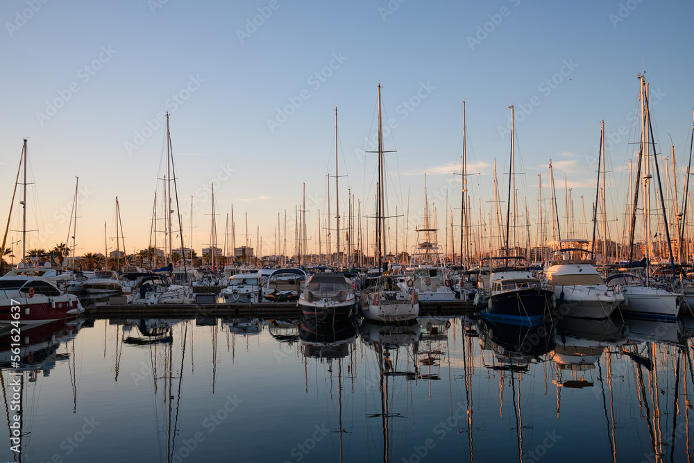 Yacht parking in the marina at sunset.
Sea bay with yachts at sunset.
Moored yachts. Marina, port. reflection of boat masts in sea water at sunset. Torrevieja, Alicante, Spain