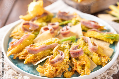 Pumpkin flowers fried with anchovies and cheese. Traditional cuisine of Italy, south of Italy and Sardinia. Little salty fish and flowers. Close-up