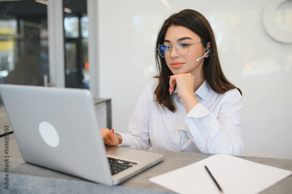 friendly young woman behind the reception desk administrator friendly young woman behind the reception desk administrator