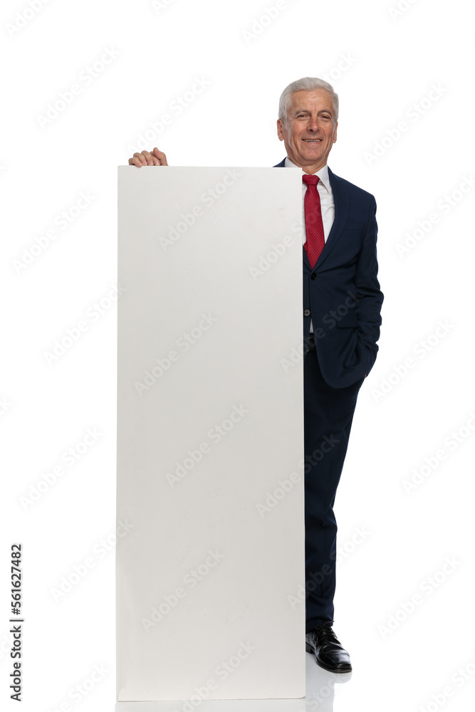 businessman presenting something on a vertical billboard businessman presenting something on a vertical billboard