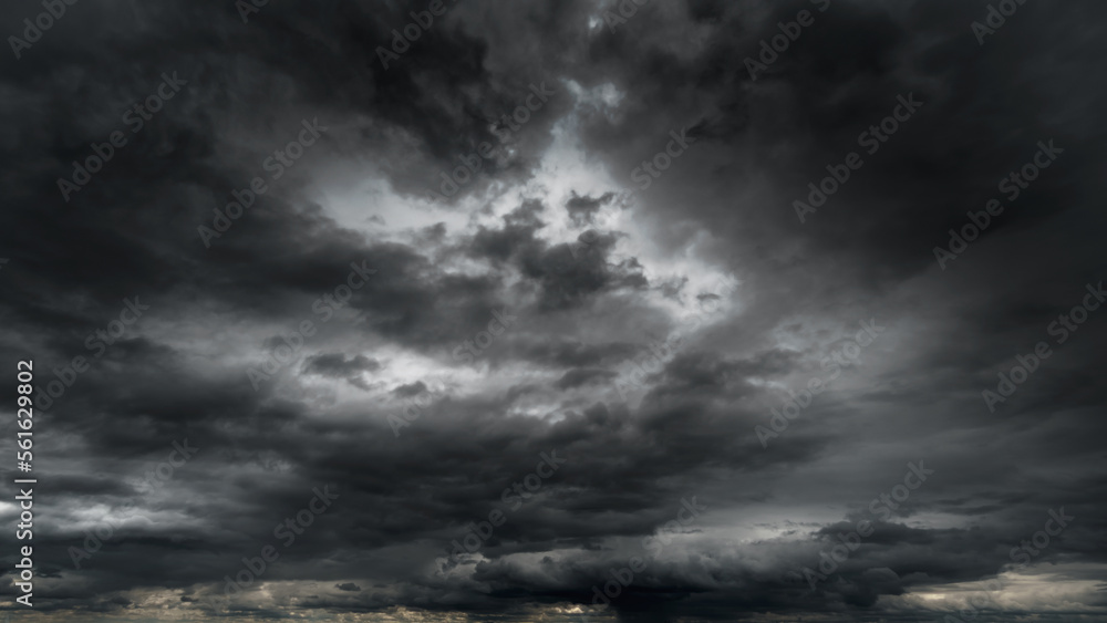 dark dramatic sky with black stormy clouds before rain or snow as abstract background, extreme weather, the sun shines through the clouds, high contrast photo dark dramatic sky with black stormy clouds before rain or snow as abstract background, extreme weather, the sun shines through the clouds, high contrast photo