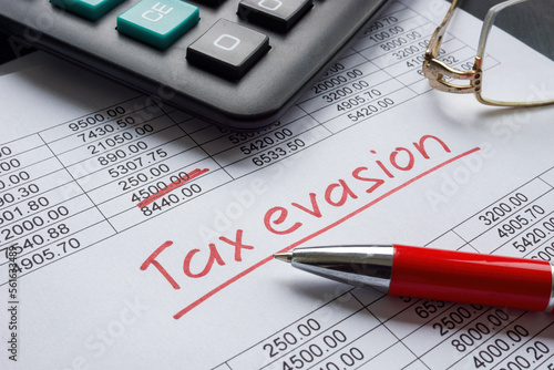 Konstfotografi Tax evasion handwritten sign on the financial data.