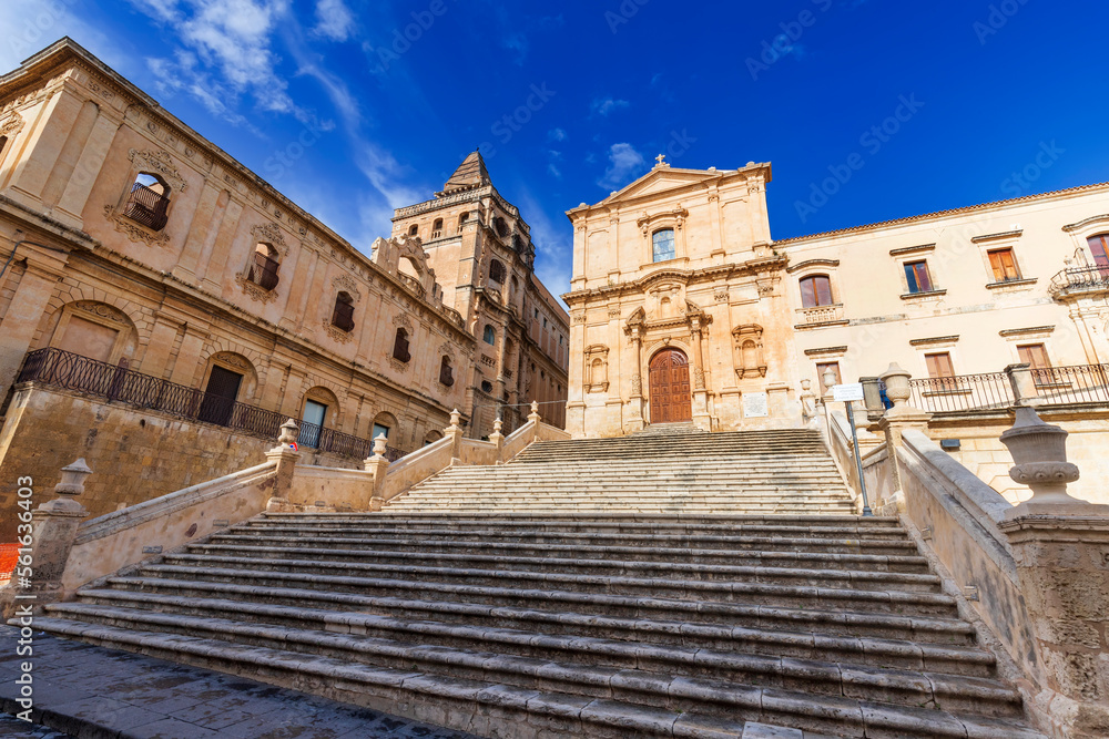 Church of Saint Francis of Assisi, an iconic building in the historical center of Noto, a picturesque town in Sicily, Italy. To the left, is the building of Seminario Vescovile.