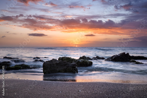 Sun setting into Gulf of mexico at Venice, Florida USA photo