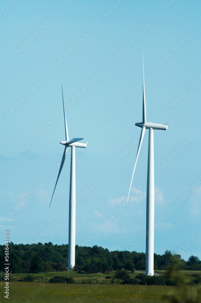 windmills stand against a blue cloudy sky windmills stand against a blue cloudy sky