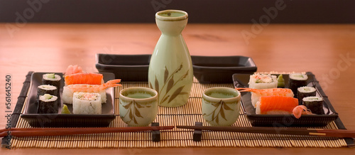 a sushi set whit sake on a wood table