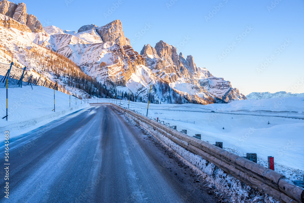 Deserted icy mountain pass road in the Alps at sunset Deserted icy mountain pass road in the Alps at sunset