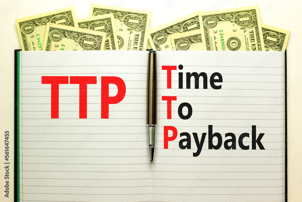 TTP time to payback symbol. Concept words TTP time to payback on white note on a beautiful background from dollar bills. Business TTP time to payback concept. Copy space. TTP time to payback symbol. Concept words TTP time to payback on white note on a beautiful background from dollar bills. Business TTP time to payback concept. Copy space.