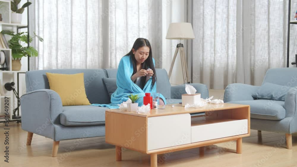 Sick Asian Woman With Blanket Taking Medicine On Sofa In The Living Room At Home
Sick Asian Woman With Blanket Taking Medicine On Sofa In The Living Room At Home