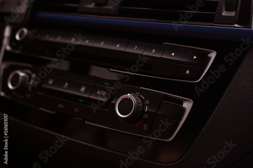 Radio tape recorder in the car. Black panel with buttons and music control. High quality photo