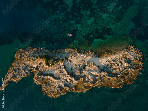 Aerial drone view of a deserted island in the sea, showcasing the beauty and serenity of a remote paradise