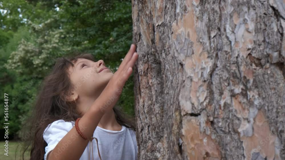 Eco child in tree reservation. An eco little girl relax and embrace the tree oak in the forest. A concept of no pollution and clean forests in the world. Eco child in tree reservation. An eco little girl relax and embrace the tree oak in the forest. A concept of no pollution and clean forests in the world.