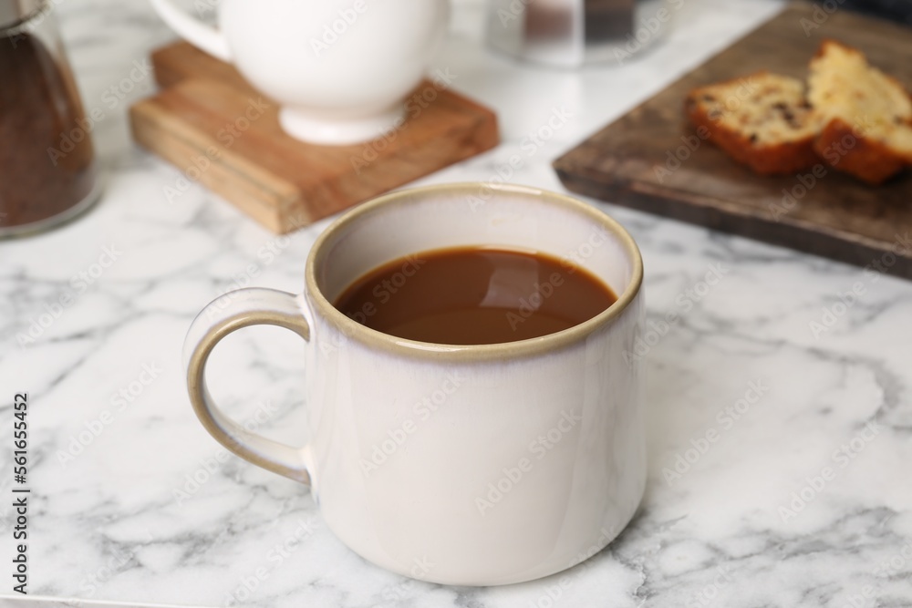 Cup of fresh aromatic coffee on white marble table Cup of fresh aromatic coffee on white marble table