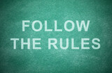 Phrase Follow The Rules written on green chalkboard