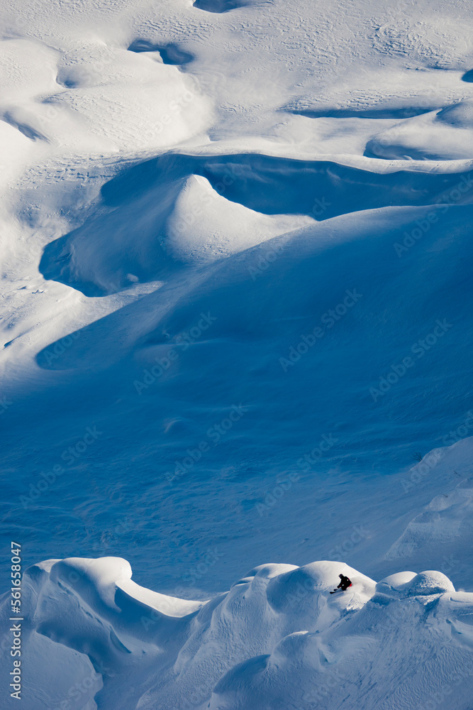 Man skiing down powdering, steep mountain. Man skiing down powdering, steep mountain.