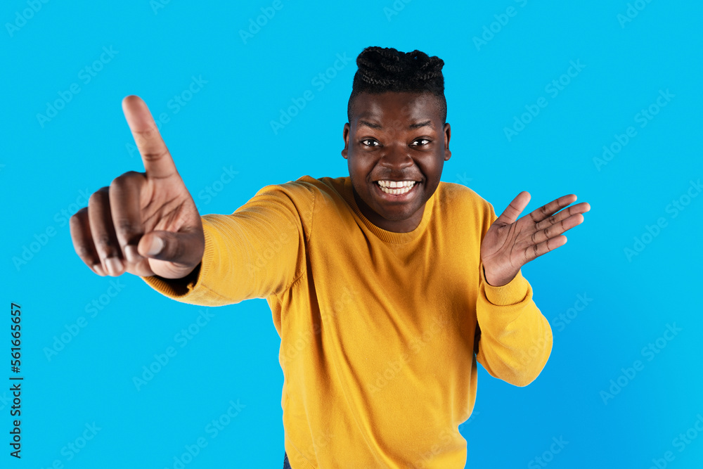 Fototapeta premium Gotcha. Cheerful Young Black Male Poiting At Camera With Finger