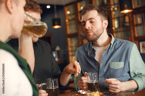 Men celebrate St. Patrick's Day at bar with a mug of beer