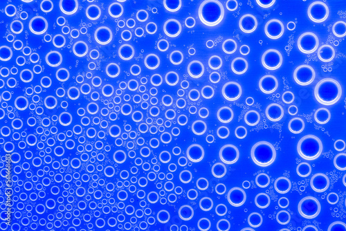 Bubbles blue background.Indigo pattern with white circles. Macro round bubbles texture in blue tones.beautiful Indigo background with circles.macro Bubbles set. 