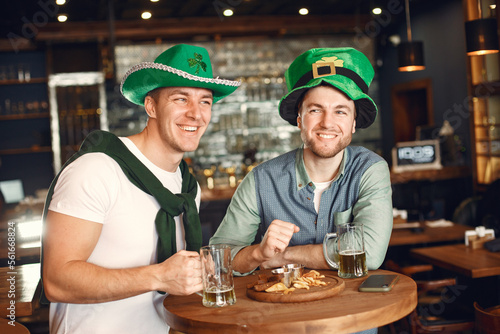 Men celebrate St. Patrick s Day at bar with a mug of beer