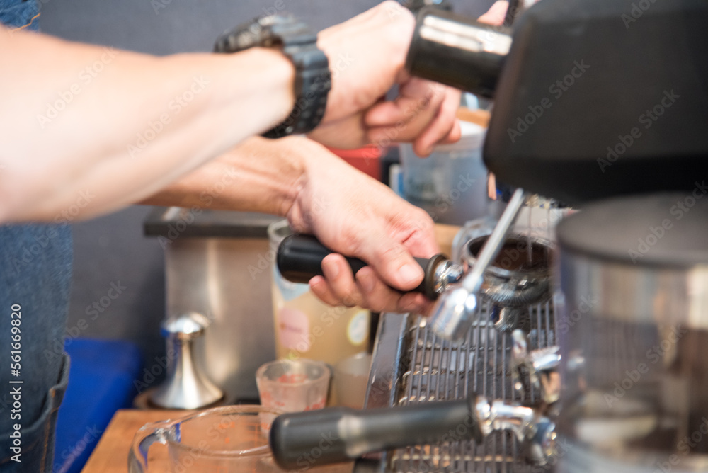 Close up hands coffee barista man make hot cup espresso shot from coffee machine. Cappuccino with milk in italian coffee shop cafe. Close up hands of barista use machine make black drinking hot cup