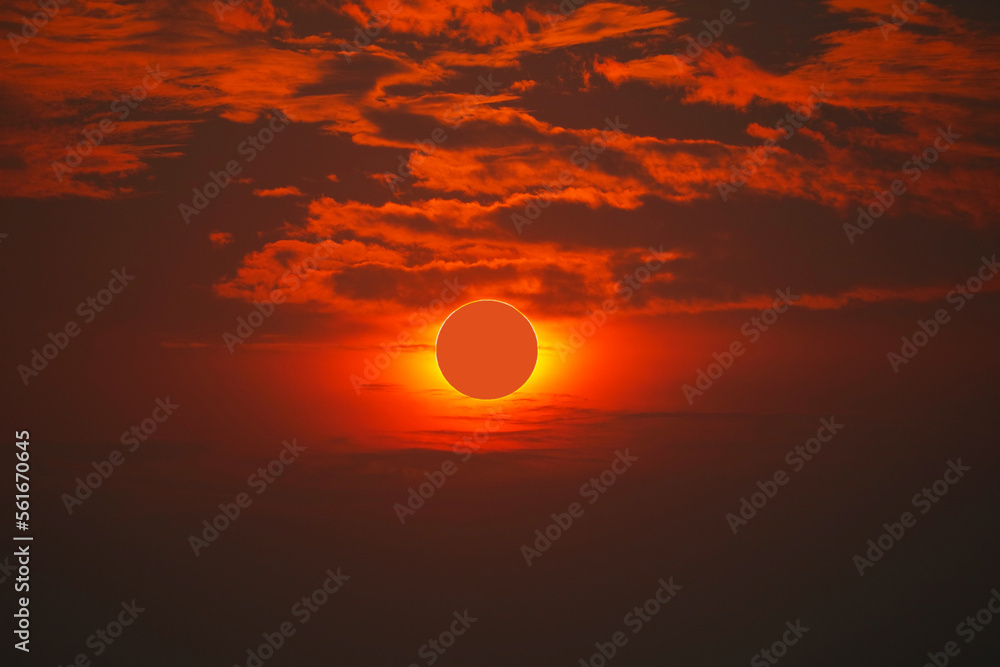 Solar eclipse on clear red orange sky sunset in the evening