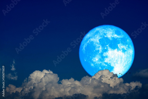 Super worm moon on the night sky back dark gray cloud