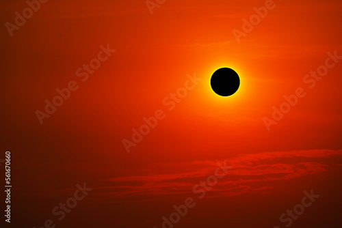 Total solar eclipse on clear red orange sky sunset in the evening