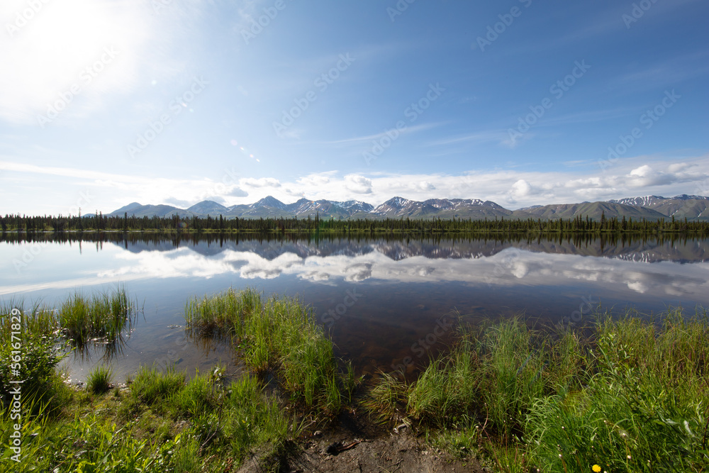 mountain range with small pond in alaska 