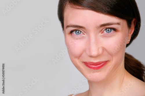 Close up studio portrait of cheerful attractive young woman.