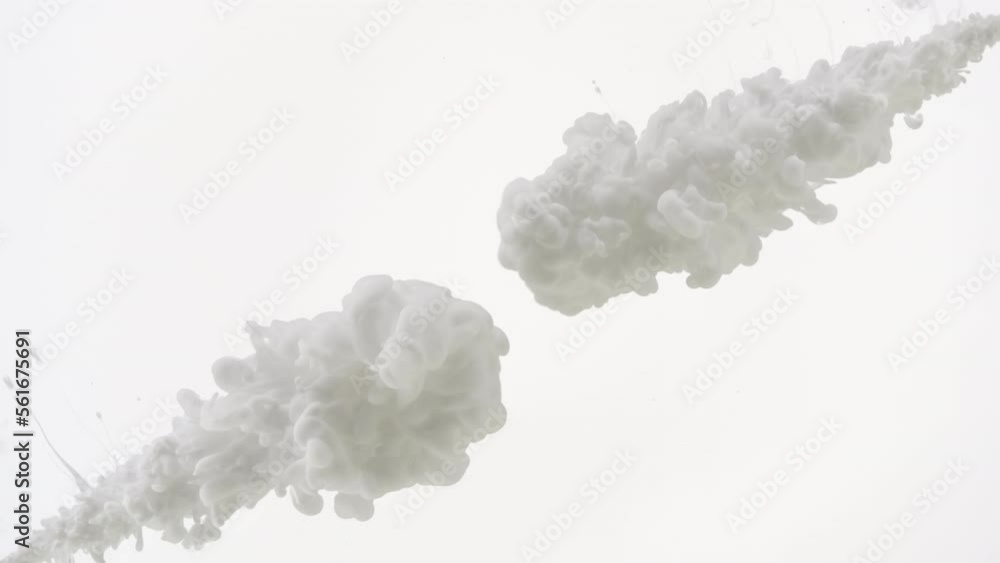 Background shot for skin lightening cosmetics commercial | Macro shot of white ink is being injected in water from two different corners on white background Background shot for skin lightening cosmetics commercial | Macro shot of white ink is being injected in water from two different corners on white background