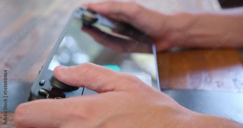 Close up playing a video game on a Steam Deck handheld game system. Soft focus shallow depth of field. The game on screen is custom-made for this footage and included with the stock license. Close up playing a video game on a Steam Deck handheld game system. Soft focus shallow depth of field. The game on screen is custom-made for this footage and included with the stock license.
