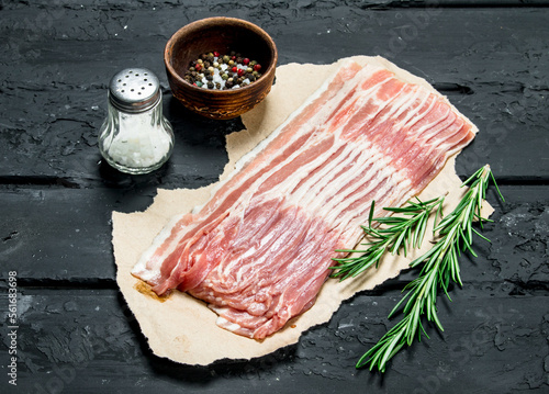 Raw bacon with rosemary and spices. photo