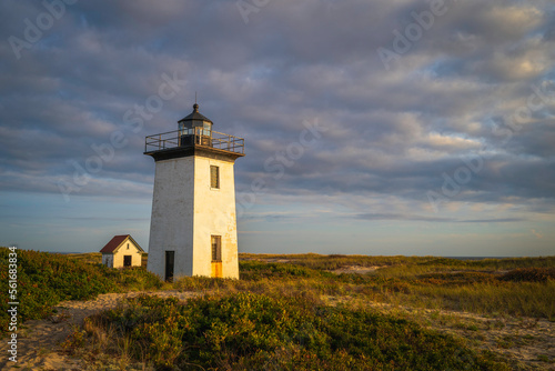 Wood End Lighthouse in Provincetown on Cape Cod, Massachusetts, USA, oceanside beach seascape at golden sunset