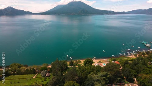 Aerial Lake and Volcano Pan Up from Coastline -  Lake Atitlan, Panajachel, Guatemala photo