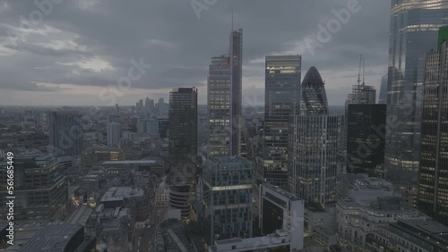 London skyline establishing shot in the dawn starts with a pan around the gherkin then flying towards canary wharf where it ends frame. Shot with Mavic 3 Cine 4K Prores 422 HQ photo