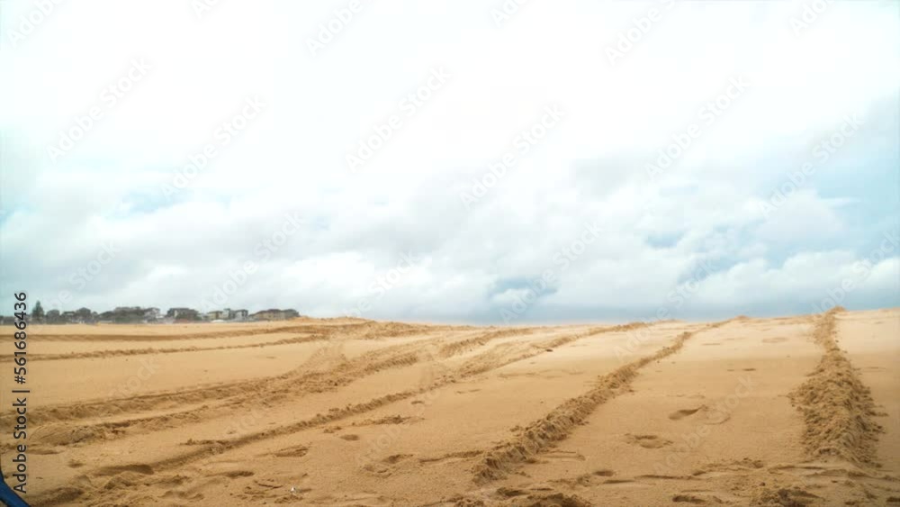 A blue chair flies through the air at the beach in slow motion as if blown by the wind A blue chair flies through the air at the beach in slow motion as if blown by the wind