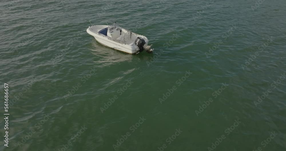 isolated small white boat aerial view on ocean lake bay water isolated small white boat aerial view on ocean lake bay water
