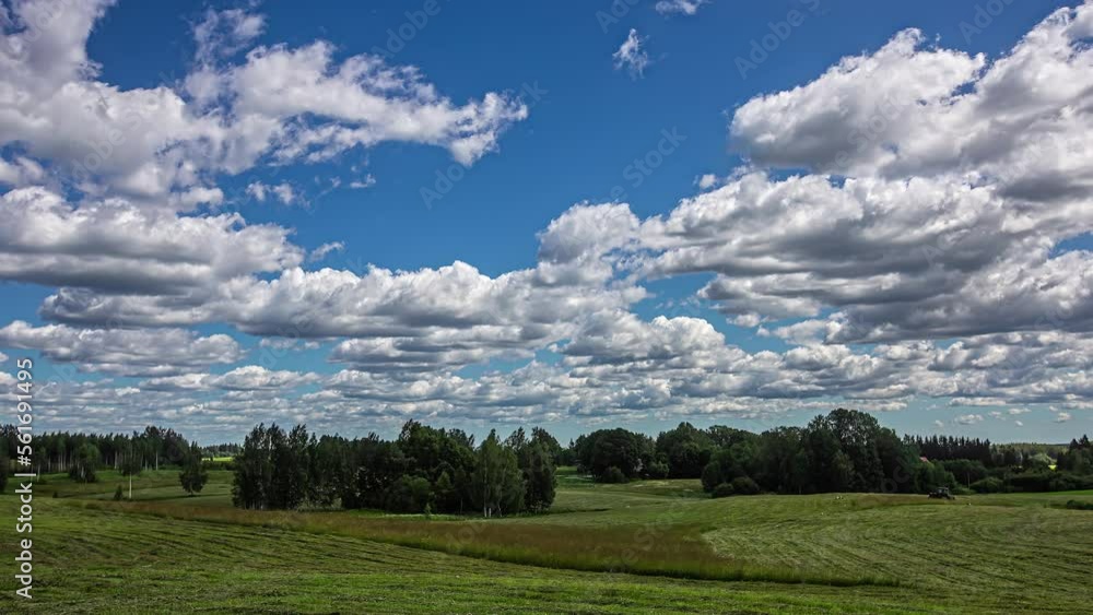 Fluffy clouds and endless farmland with tractor working, fusion time lapse Fluffy clouds and endless farmland with tractor working, fusion time lapse
