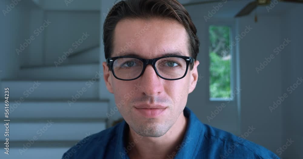 Student with bad eyesight puts on glasses to see better indoors. Close up male student looking and unable to read the text without the help of glasses on background of home office. Poor vision concept Student with bad eyesight puts on glasses to see better indoors. Close up male student looking and unable to read the text without the help of glasses on background of home office. Poor vision concept